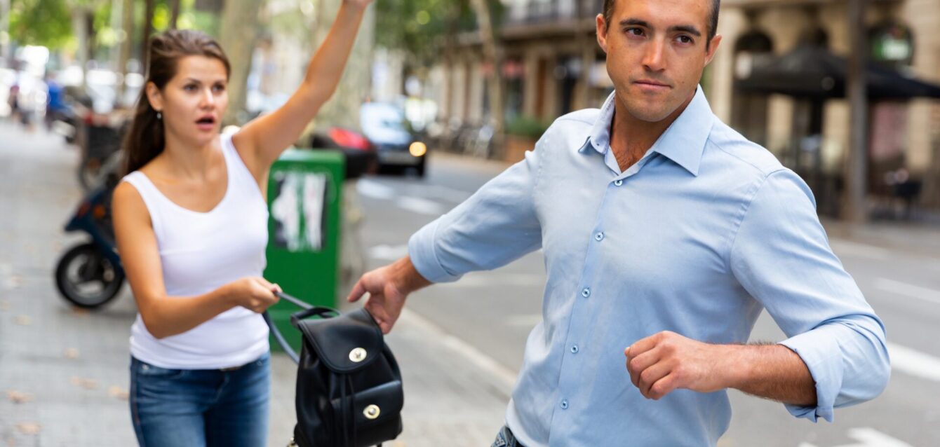 Hombre robando mochila a mujer en la calle